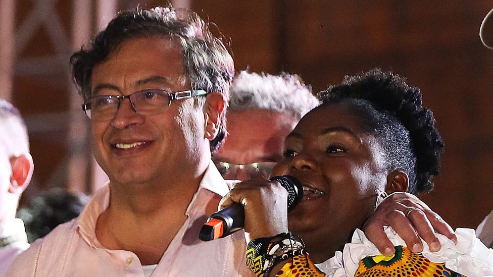 Colombian presidential candidate left-wing Gustavo Petro, listens to Francia Marquez as she delivers a speech during a campaign rally in Cali, Colombia, May 19, 2022.