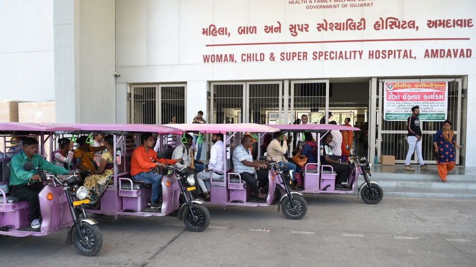 Электронные рикши припаркованы возле больницы Гуджарата