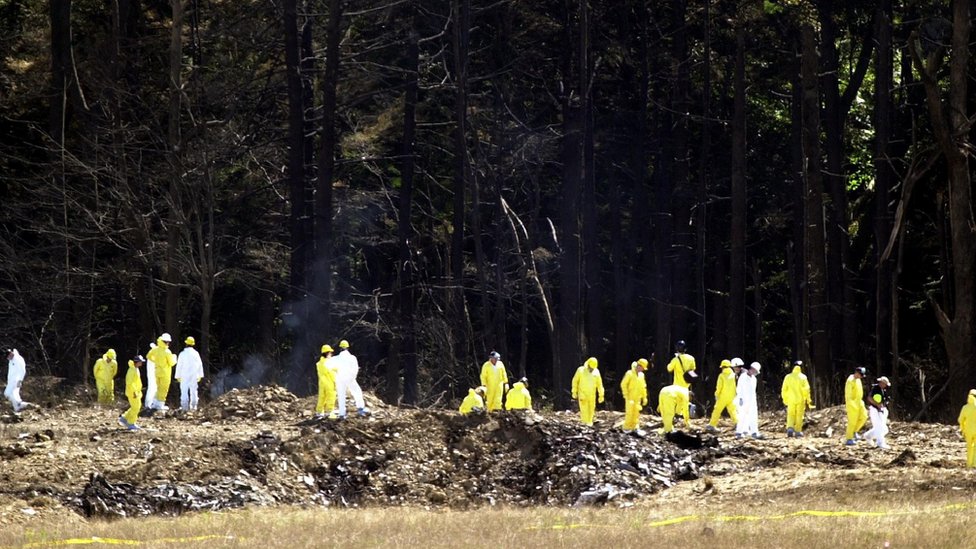 Investigators comb the debris field for the flight data recorders from United Airlines Flight 93 near Shanksville, Pennsylvania, September 12, 2001