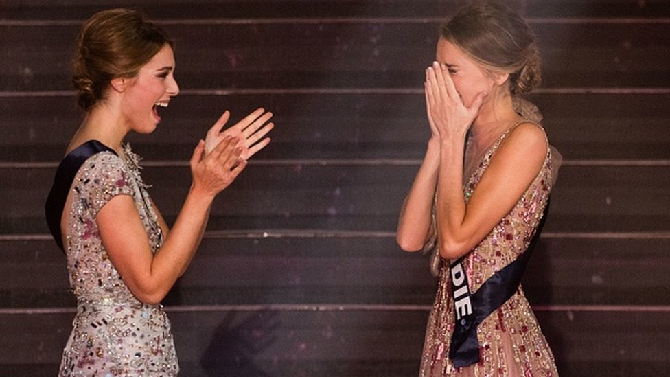 Newly elected Miss France 2021 Miss Normandie Amandine Petit (R) reacts in front of Miss Provence April Benayoum