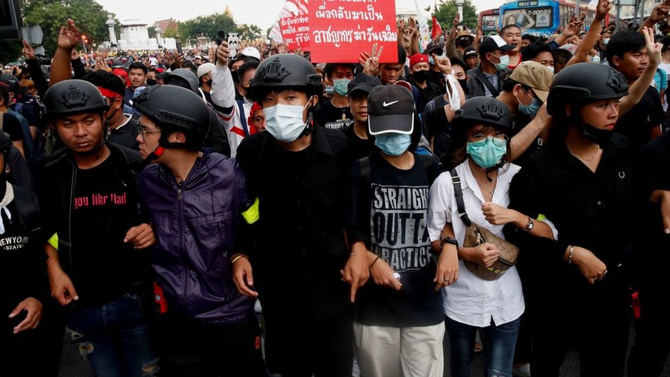 Pro-democracy demonstrators make a human chain as they march during a Thai anti-government mass protest, on the 47th anniversary of the 1973 student uprising, in Bangkok, Thailand October 14, 2020.