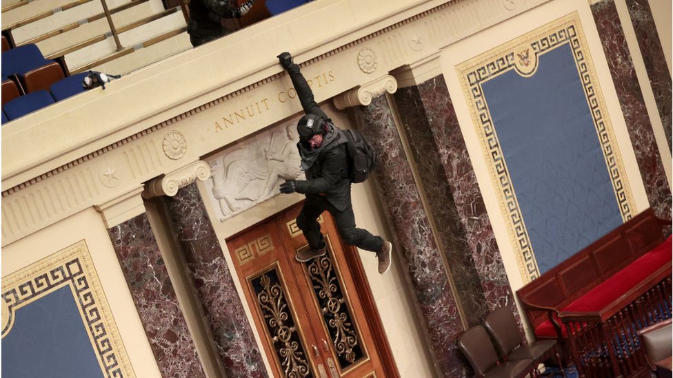 Officials have named the dangling rioter above as Josiah Colt of Idaho