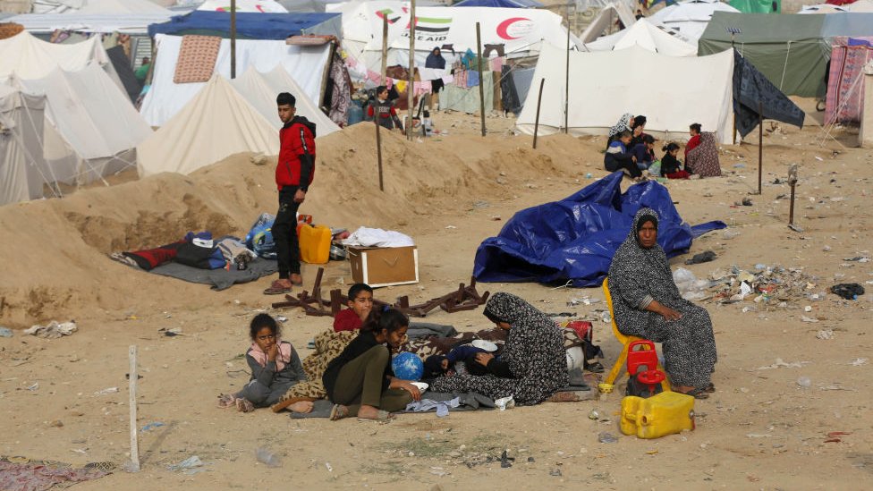 Palestinians who migrated from the Burayj Refugee Camp to Deir al-Balah are seen around tents in an empty area of Deir al-Balah, Gaza