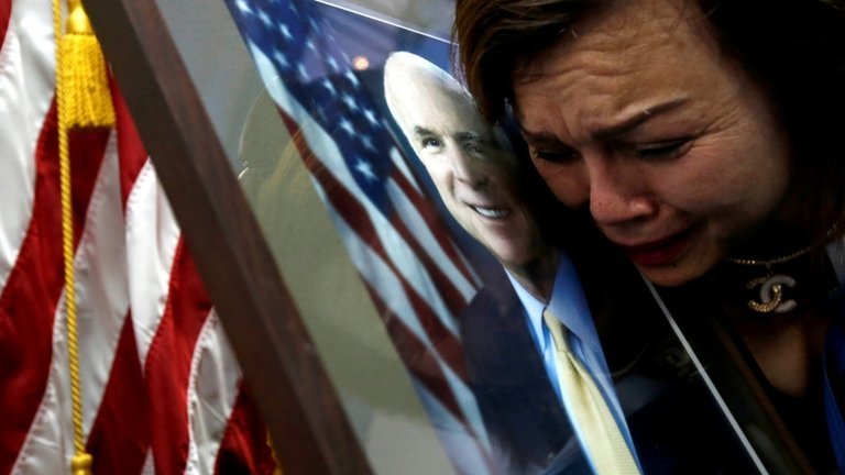 woman cries over McCain image in Hanoi