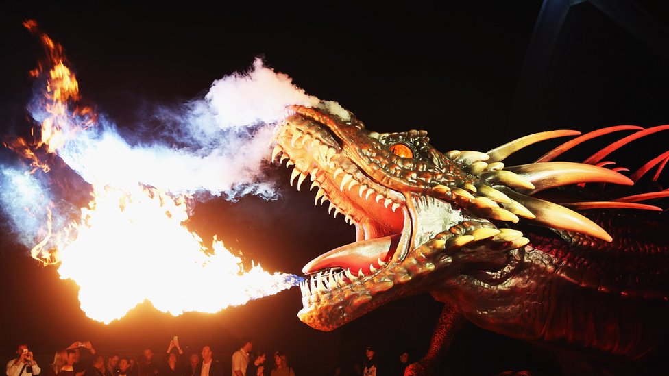 A dragon statue emits fire as people look on the Sydney premiere of "Game Of Thrones" at Sydney Opera House on April 13, 2015 in Sydney, Australia