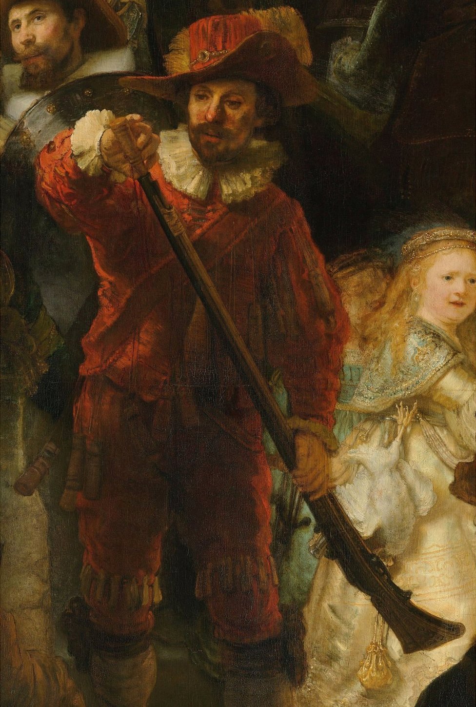 Mosquetero vestido de rojo con cuello y puños blancos, está cargando su mosquete con pólvora, y una joven vestida de dorado.