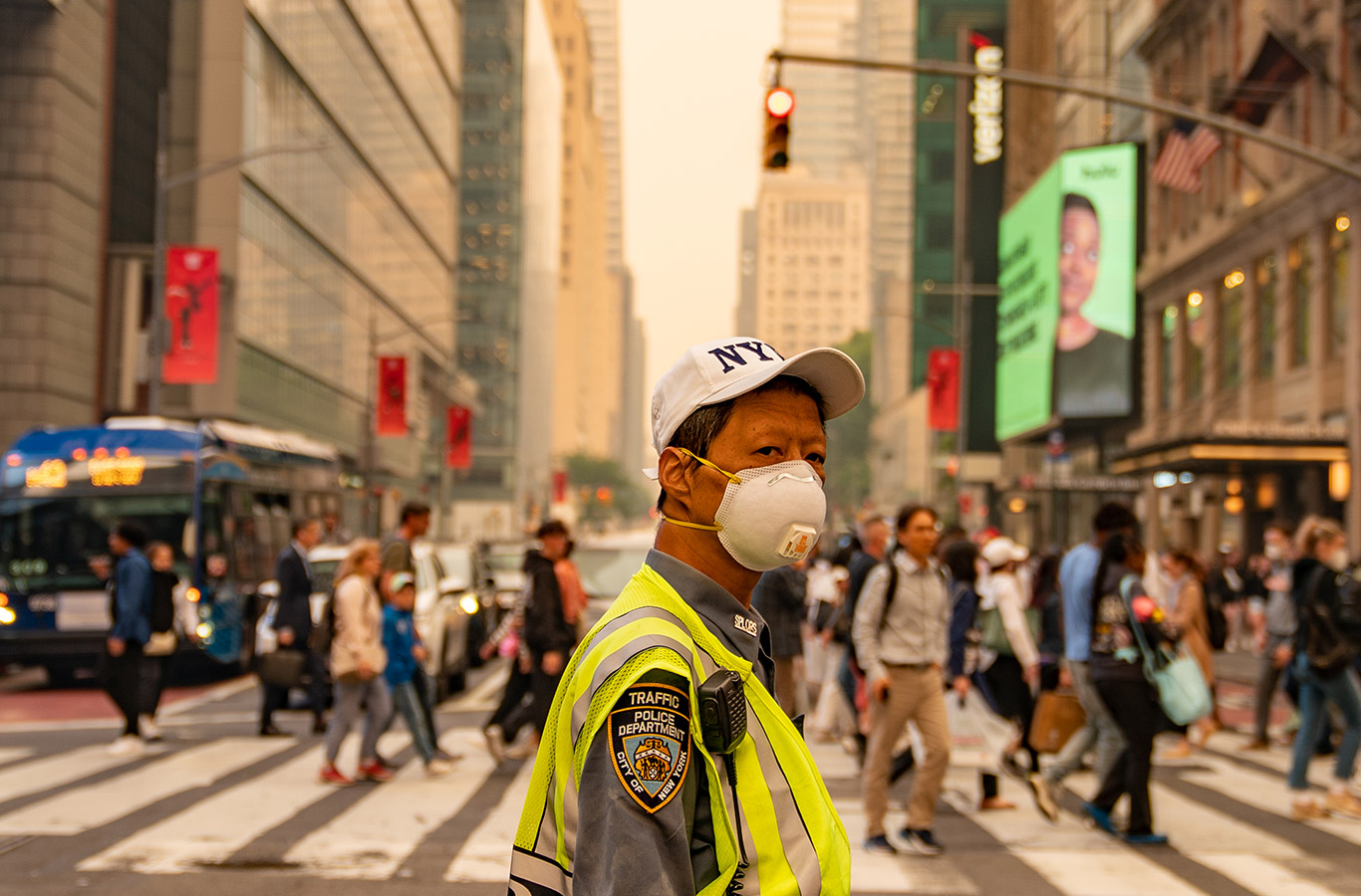 A traffic officer wears an N95 mask in Times Square amid a smoky haze from wildfires in Canada