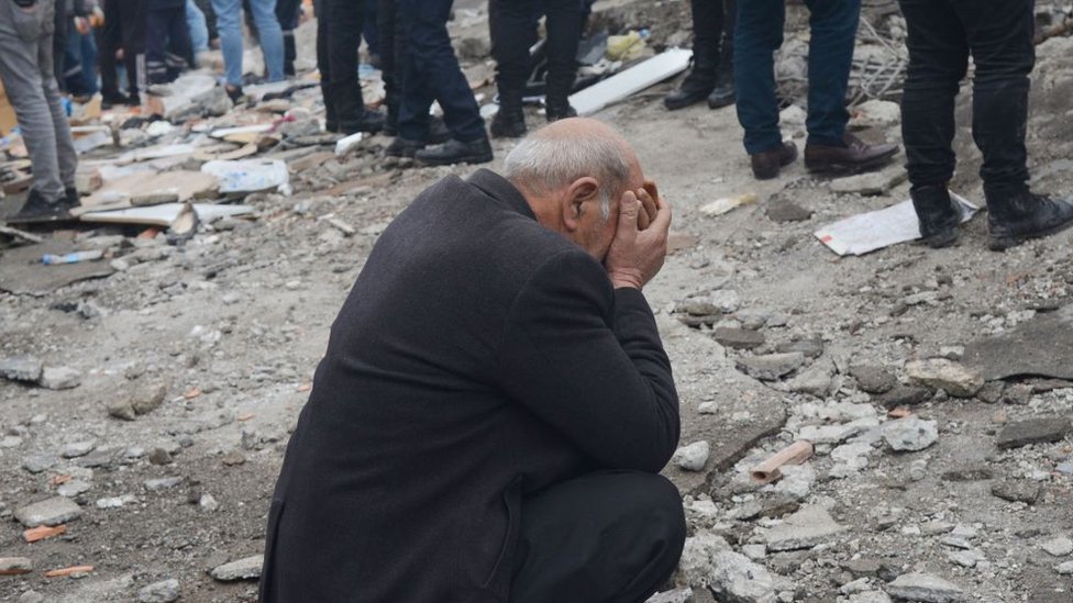 A man reacts as people search for survivors through the rubble in Diyarbakir, north-east of Gaziantep