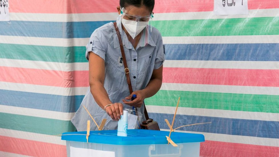 A voter casts her ballot at a polling station in Yangon on November 8, 2020.