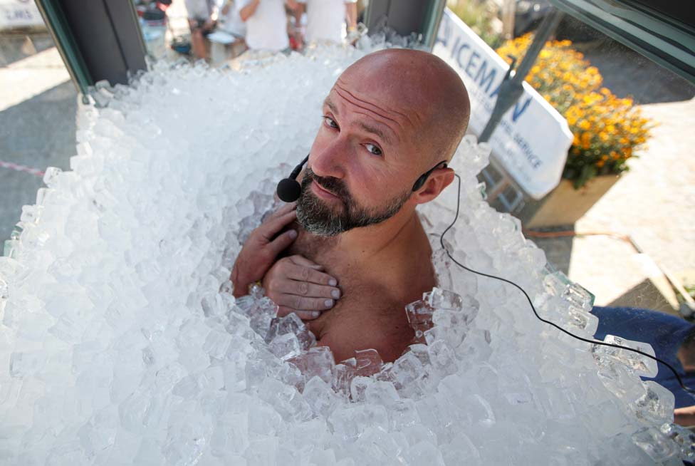 Austrian sportsman Josef Koeberl stands in an ice-filled glass cabin in Melk, Austria