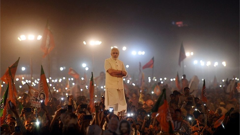Indian supporter listens as Indian Prime Minister Narendra Modi (not pictured) delivers a speech during a rally ahead of Phase VI of India's general election in New Delhi on May 8, 2019.