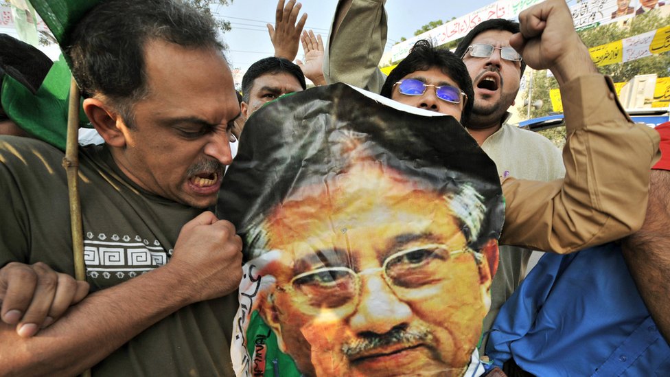 Activists of former Pakistani premier Nawaz Sharif's party, the Pakistan Muslim League-Nawaz, beat a poster of former Pakistani president Pervez Musharraf during a protest in Lahore on November 3, 2008
