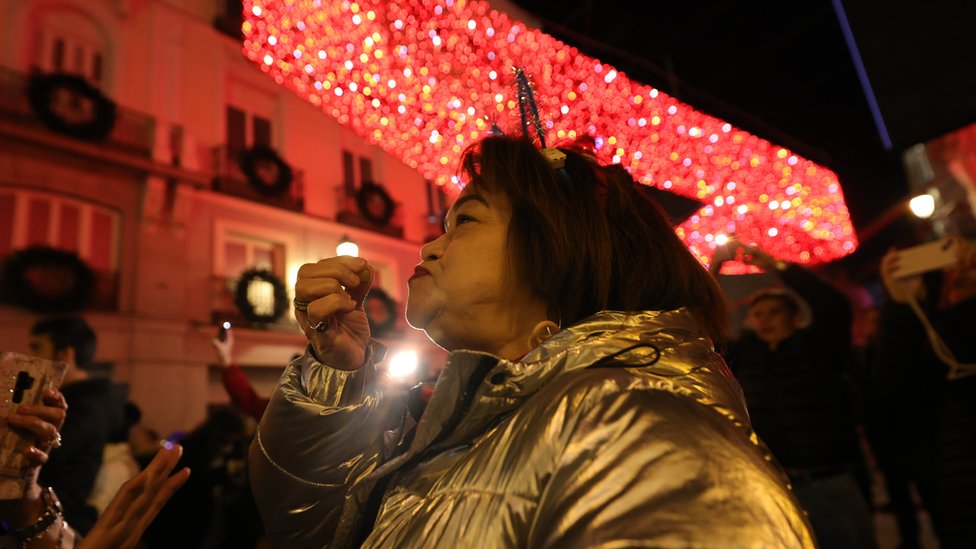 Seorang perempuan memakan anggur setelah Lonceng Malam Tahun Baru 2022, di Puerta del Sol, pada 1 Januari 2023, di Madrid, Spanyol.