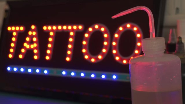 Neon sign with word; "Tattoo"