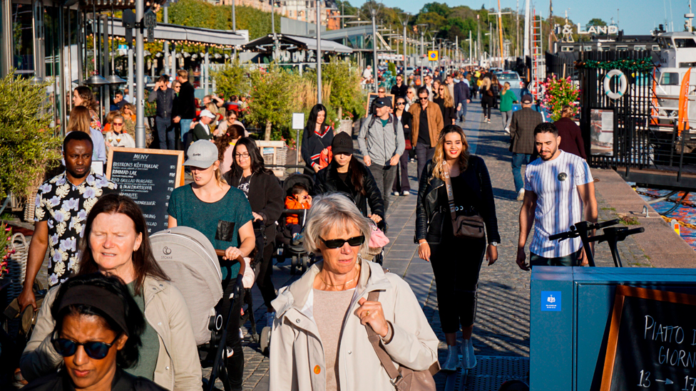 People walk on Stranvagen in Stockholm