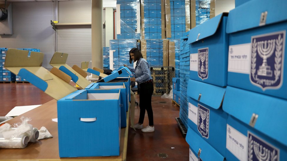 A woman sorts ballot boxes at the Israel Central Election Committee Logistic Centre in Shoham (6 March 2019)