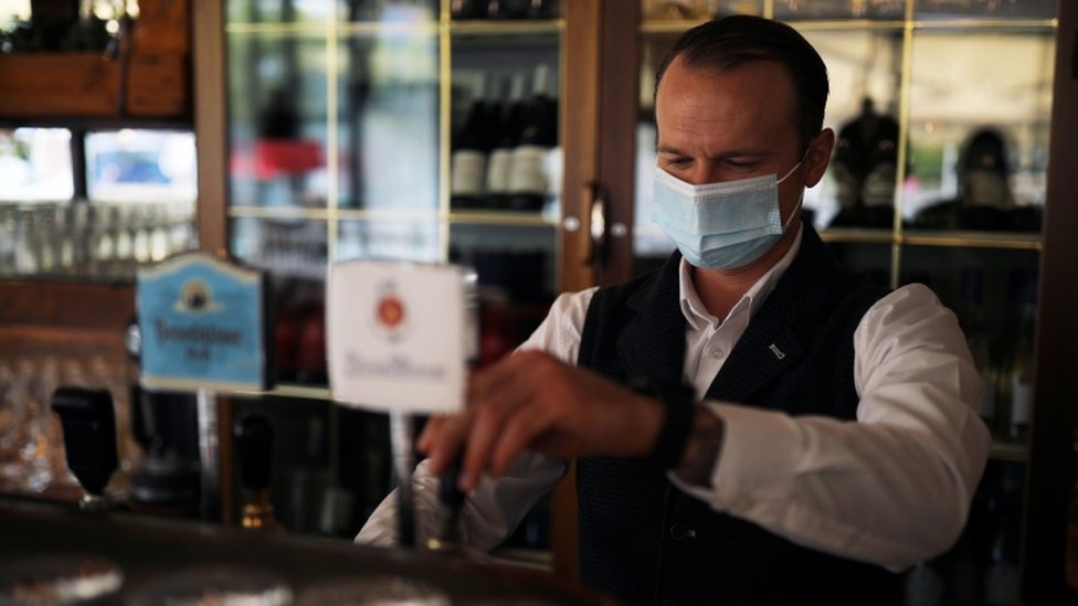 Waiter Ivan wearing a protective face mask works at the Francucci's Ristorante, amid the coronavirus disease outbreak, in Berlin, Germany, October 1, 2020