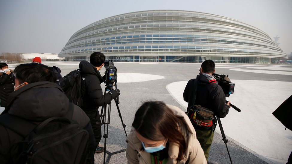 Media reporters are seen in front of the National Speed Skating Oval, a venue of the 2022 Winter Olympic Games, during an organised media tour in Beijing, China January 22, 2021.