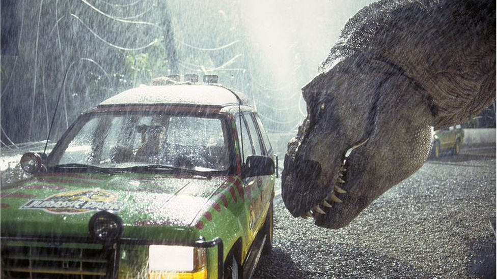 Scene from the 1993 movie Jurassic Park shows a T-Rex near a car