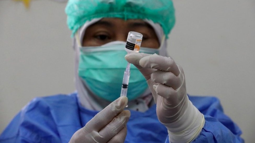 An Indonesian health worker prepares a dose of Sinovac vaccine