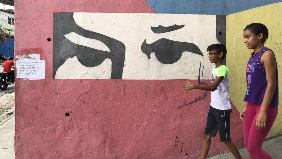 Dos niños frente a un mural en Venezuela