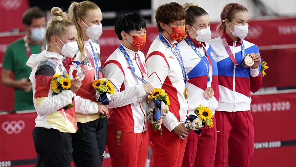鍾天使（右三）、鮑珊菊（左三）與銀牌、銅牌得主站在頒獎台上合照（2/8/2021）