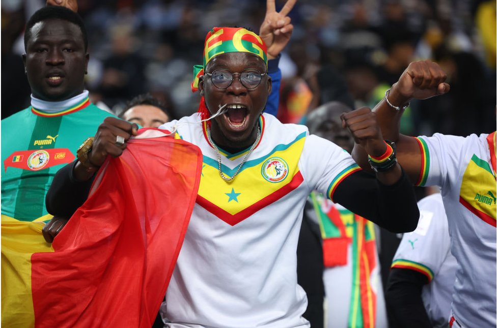 مشجع سنغالي يهتف لارتداء ألوان العلم السنغالي.