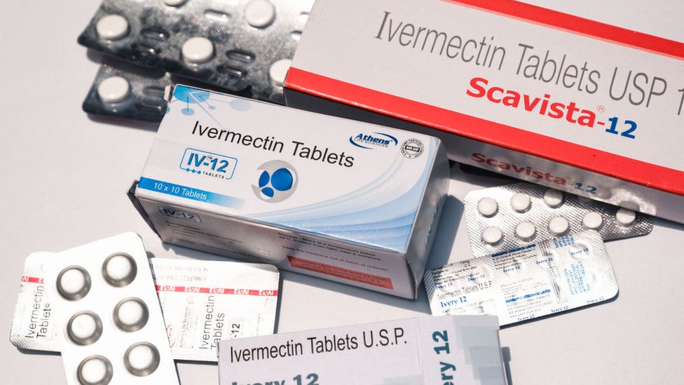 Ivermectin tablets on a table, scattered about