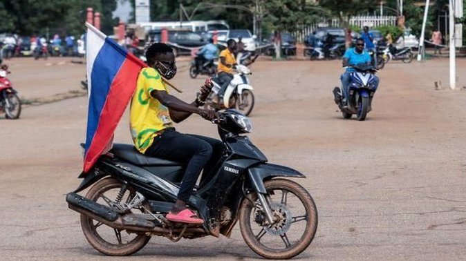 Motorbike rider carries Russian flag