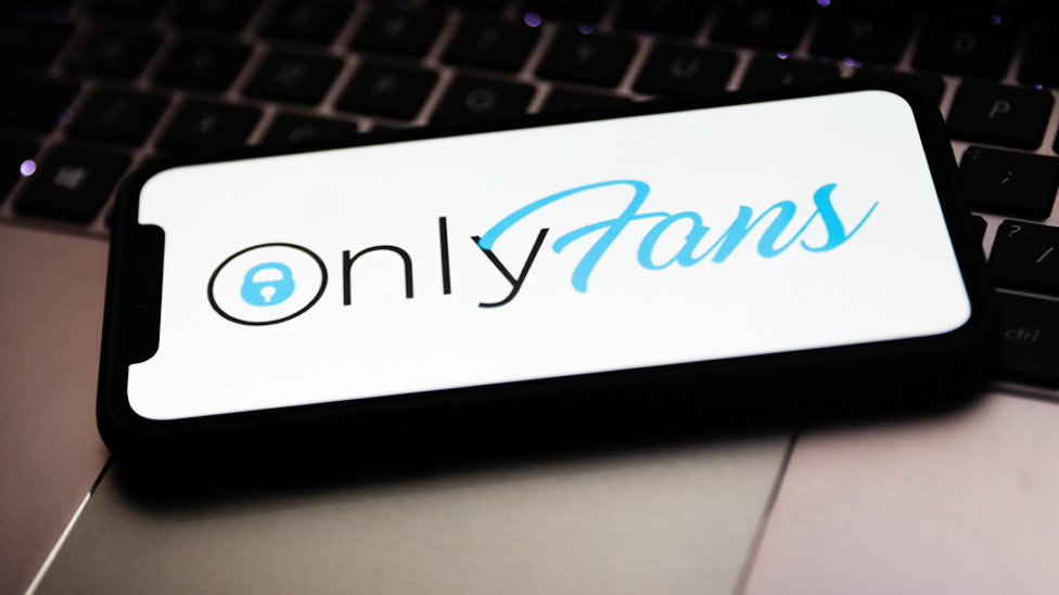 Stock image of the OnlyFans logo on a smartphone. 