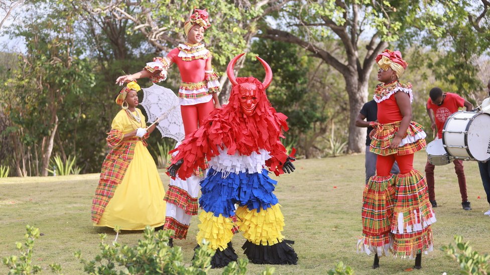Performers in colourful dress welcomed the royals on 25 April during their visit to Antigua and Barbuda