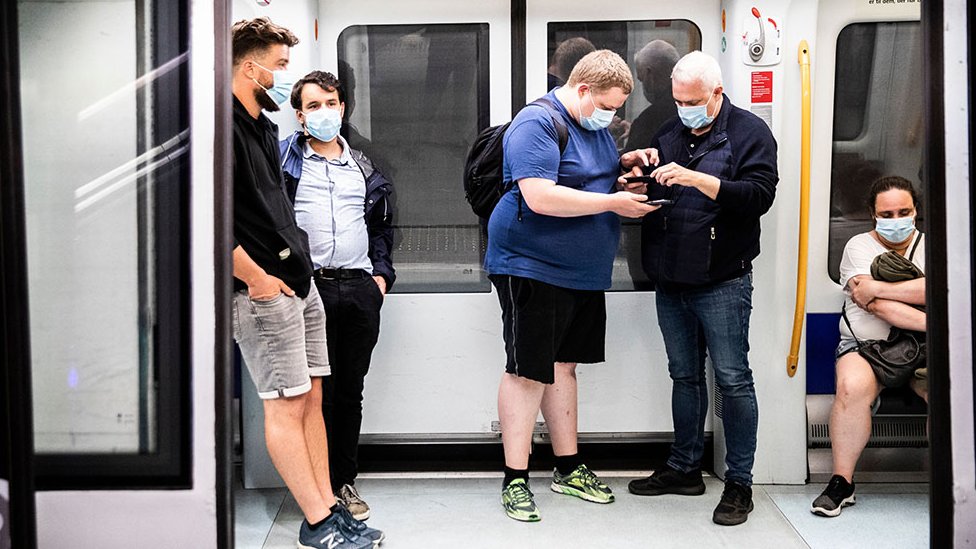 People ride the Metro wearing face masks, shortly after midnight, in Copenhagen, Denmark, 22 August 2020