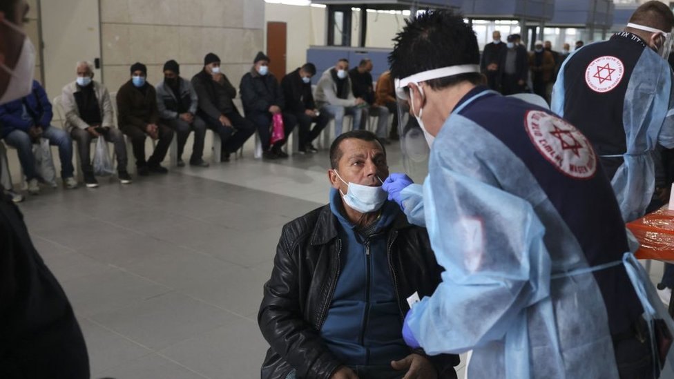 A man from Gaza is tested for COVID-19 before being admitted to Israel.