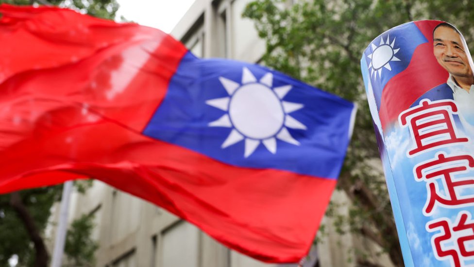 A supporter of the Kuomintang, Taiwan's main opposition party, waves a Taiwanese flag outside the Central Election Commission office in Taipei, Taiwan, on Friday, Nov. 24, 2023.