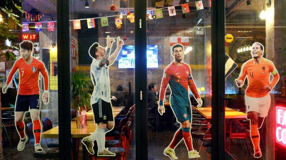 Posters of Son Heung-min, Lionel Messi, Cristiano Ronaldo and Virgil van Dijk are seen at a restaurant on November 20, 2022 in Shanghai, China