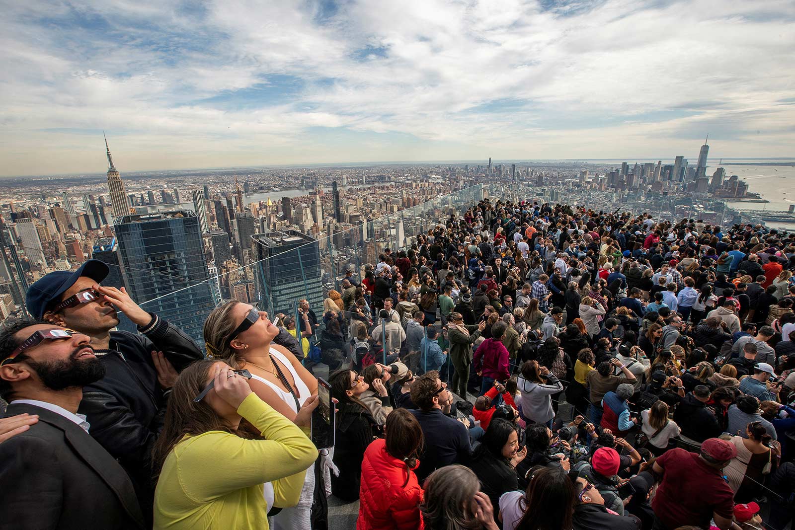 People watch the partial solar eclipse on the observation deck of Edge at Hudson Yards in New York City - 8 April 2024 (Eduardo Munoz/Reuters)