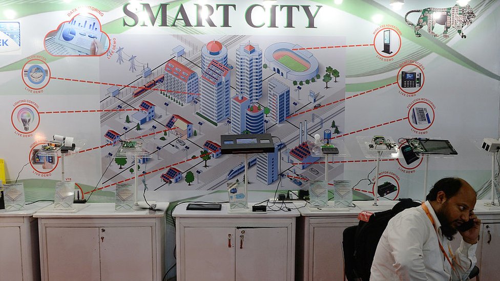 An Indian delegate talks on a phone during the Smart Cities India 2016 expo in New Delhi on May 12, 2016.