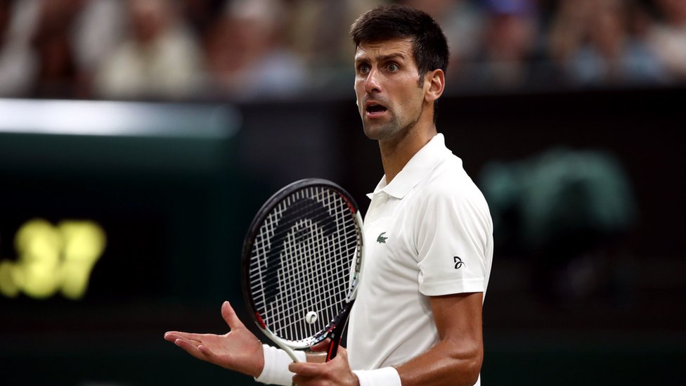 Novak Djokovic on court reacts with surprise