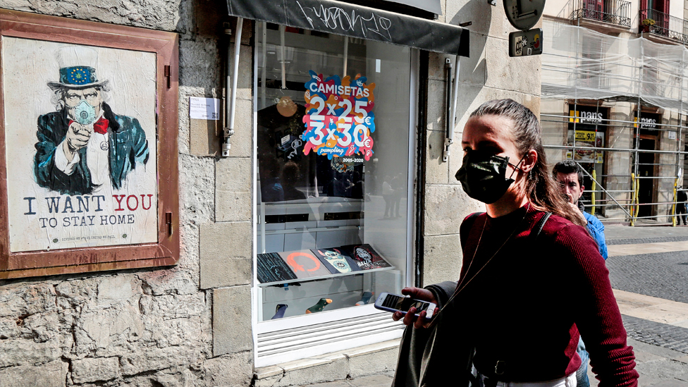 A young girl wearing a mask