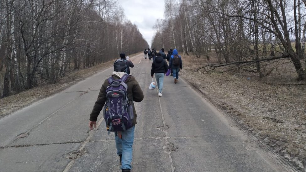 Afghan refugees walkthrough the Ukrainian countryside