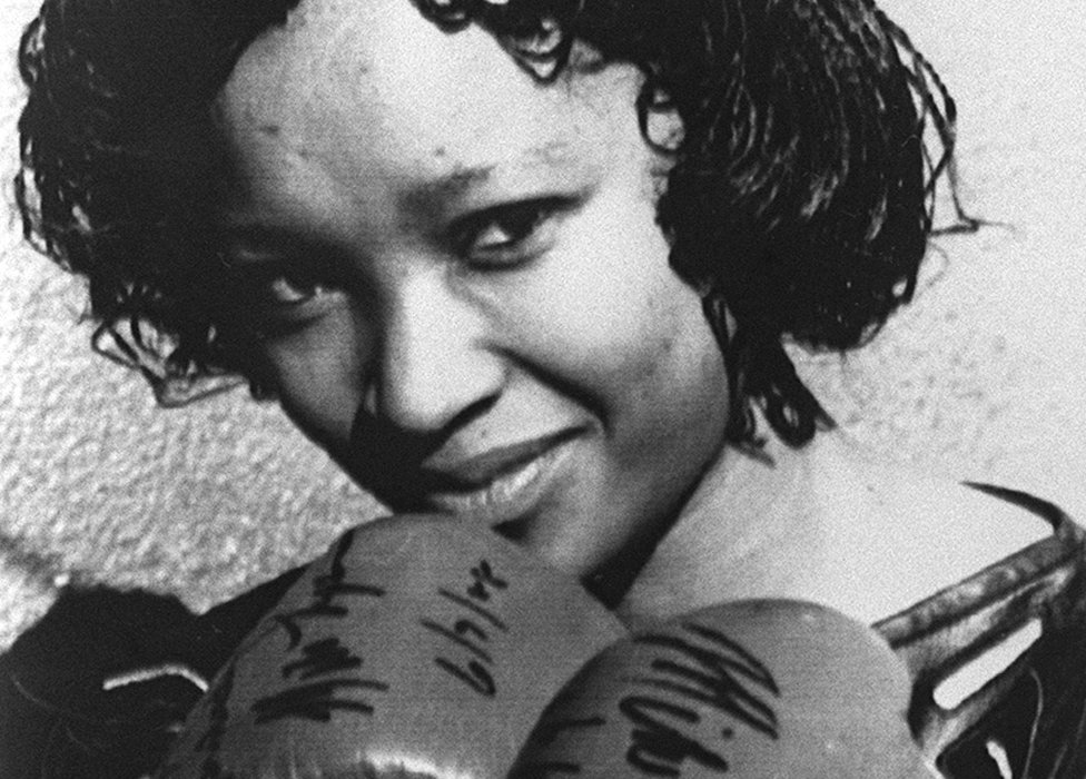 Zindzi Mandela wearing boxing gloves given to her father by the World Heavyweight Boxing Champion Mike Tyson as a present for his 70th birthday in 16 July 1988 in Soweto