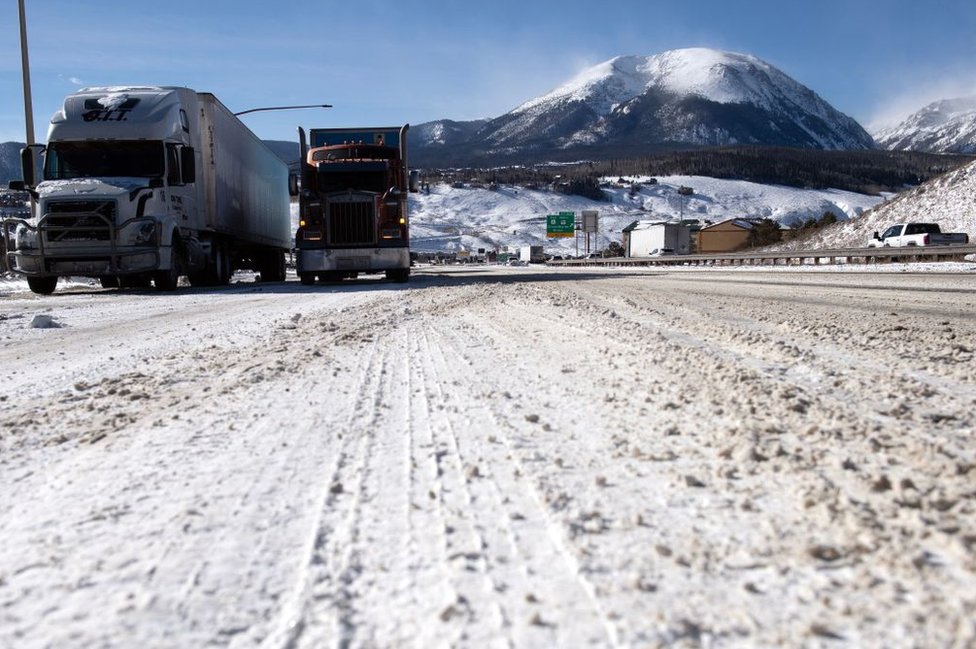 Semitrucks line up in the eastbound land on I-70 in Silverthorne, Colorado on December 22, 2022.