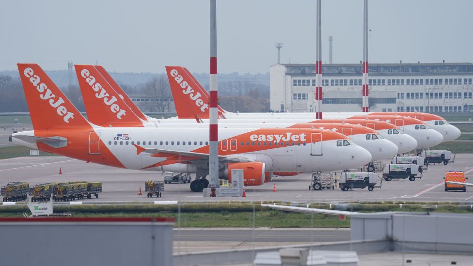 Пассажирские самолеты дисконтной авиакомпании EasyJet стоят на взлетной полосе в аэропорту Берлин-Шенефельд.