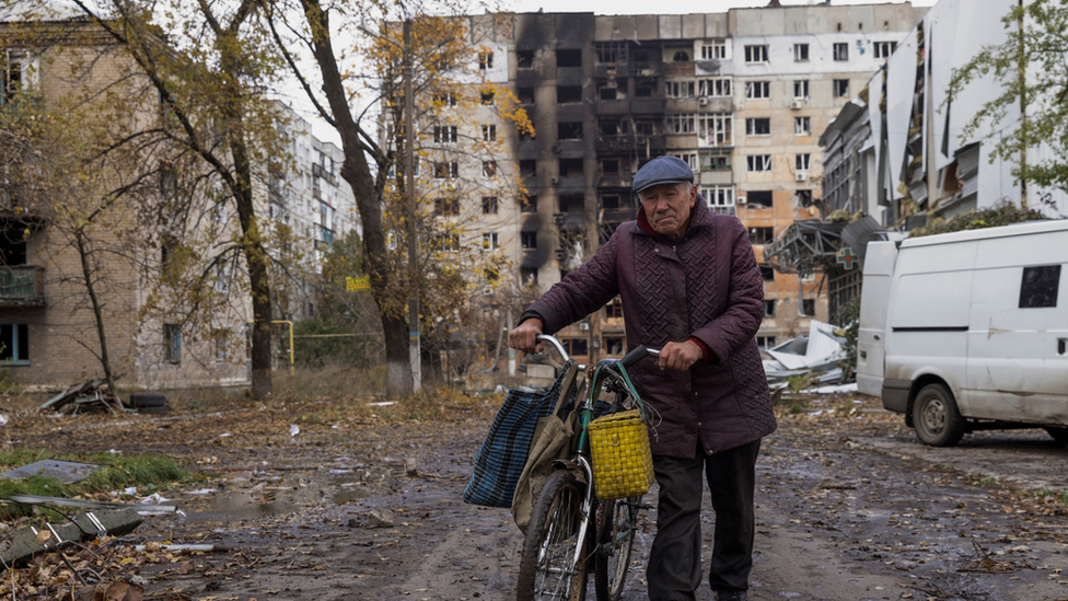 A man walks through the town of Avdiivka in eastern Ukraine, battered by Russian assault