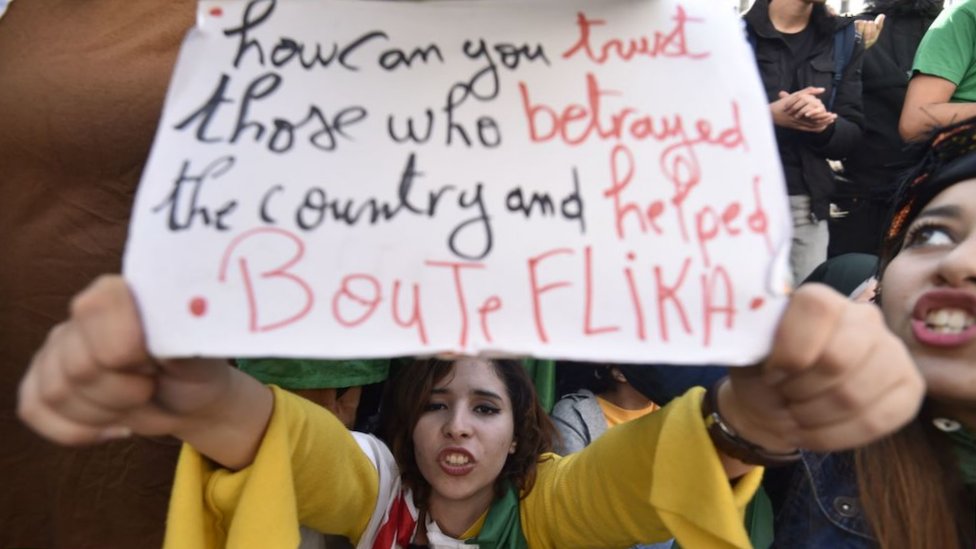 An Algerian protester holds up a placard during an anti-government demonstration in the capital Algiers on 11 December 2019, ahead of the presidential vote.