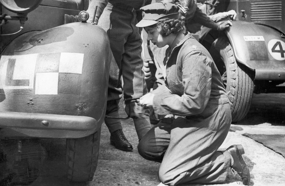 Princess Elizabeth learning basic car maintenance as a Second Subaltern in the ATS. 12 April 1945.