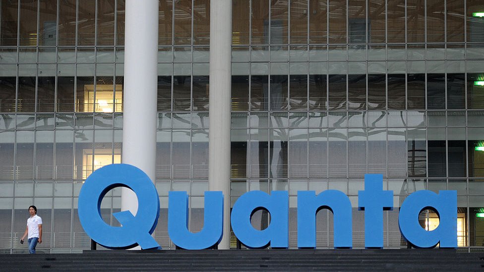 A man walks past a Quanta logo outside the company's factory in Taiwan's northern Taoyuan county on September 21, 2011.
