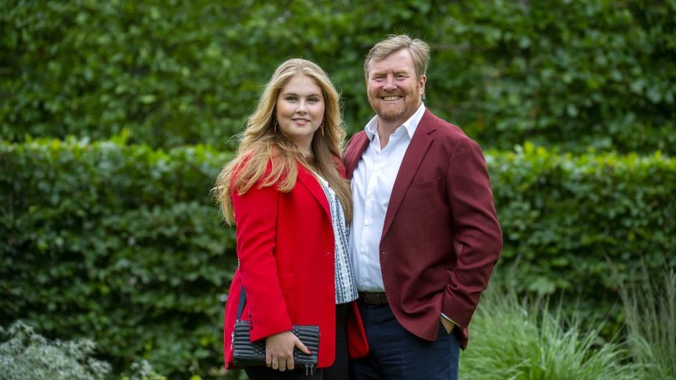 King Willem-Alexander of the Netherlands (R) and Princess Amalia pose during the summer photo session at Huis ten Bosch Palace in The Hague, on July 16, 2021