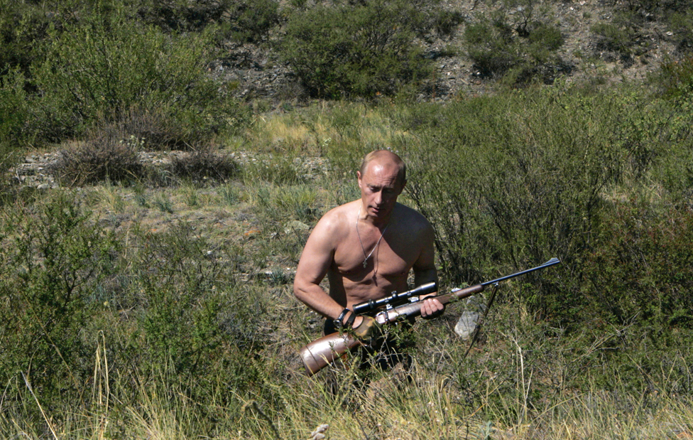 Russian President Vladimir Putin carrying a hunting rifle in the Republic of Tuva, 15 August 2007.