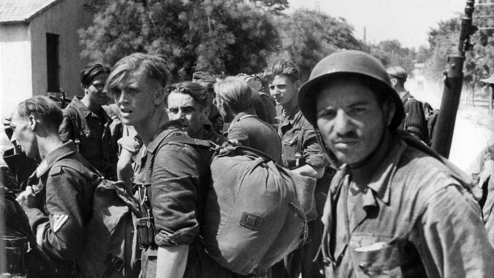 A French Algerian soldier guards captured German troops at Ste Marthe, southern France, August 1944